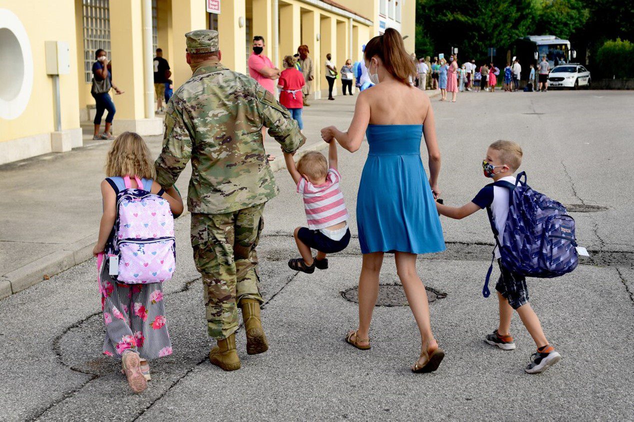 Family walking children to the first day of school on the Air force Base