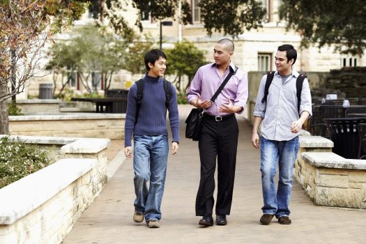 Three college students walking on campus