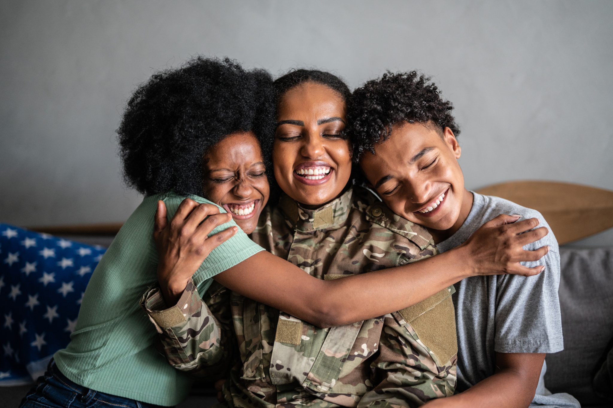 Soldier mother embracing son and daughter|Dr. Ken Ginsburg Headshot