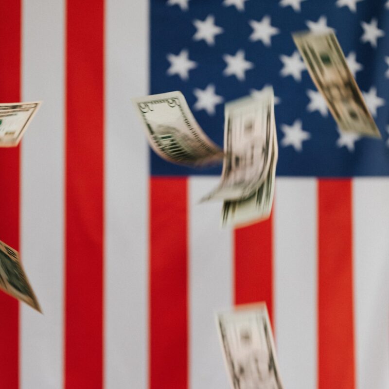 money falling in front of american flag background