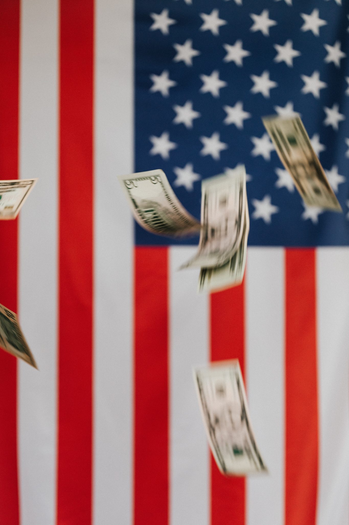 money falling in front of american flag background