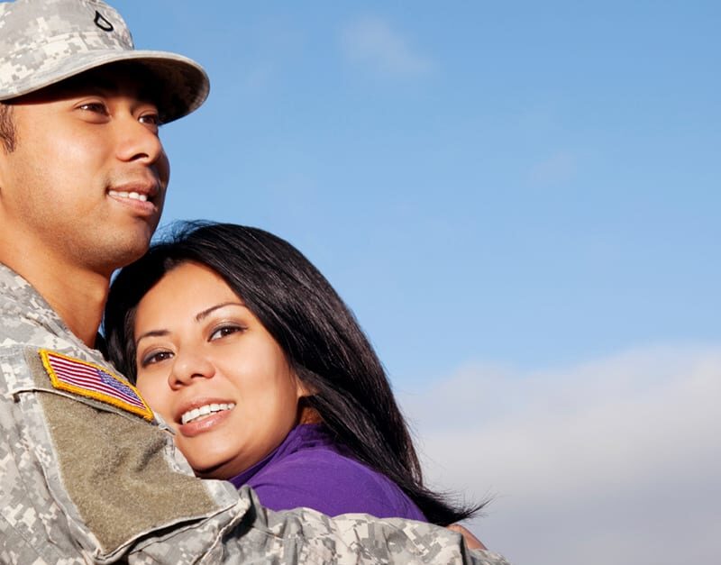 Military service member hugs military spouse in appreciation