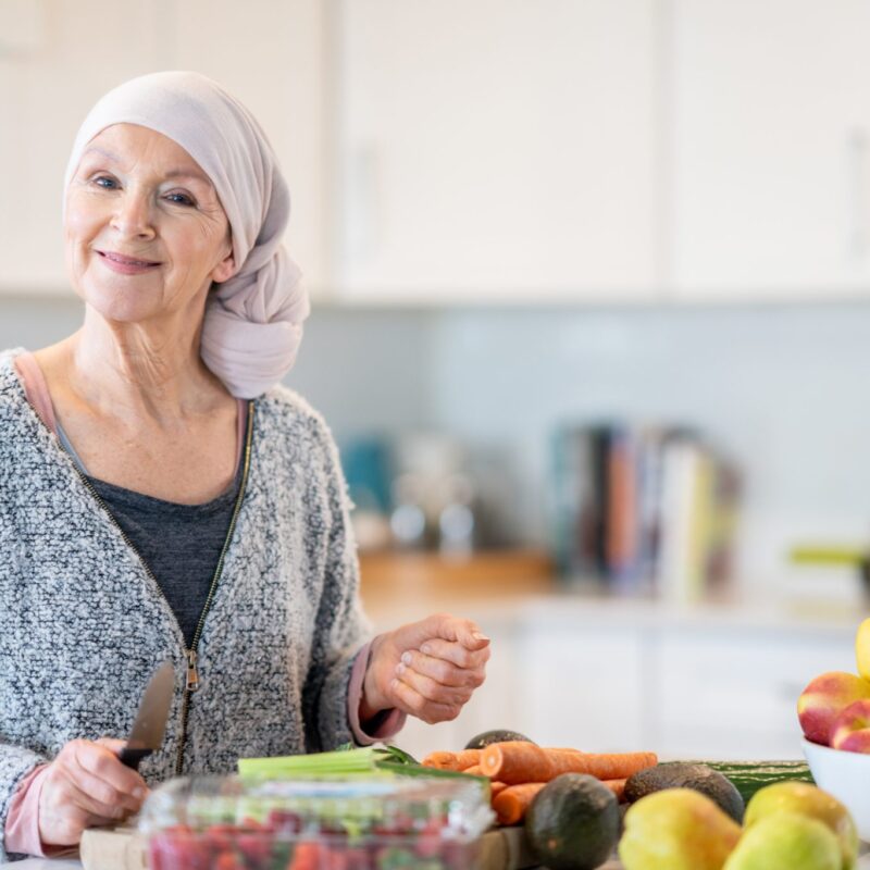 Woman with cancer cooks a health meal