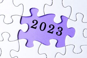 jigsaw puzzle with piece missing and in its place the numbers 2023 on a purple background