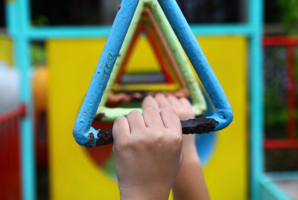 Image of children's hands on monkey bars