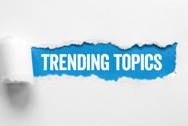 "trending topics" words revealed on a blue background from a torn section of white paper