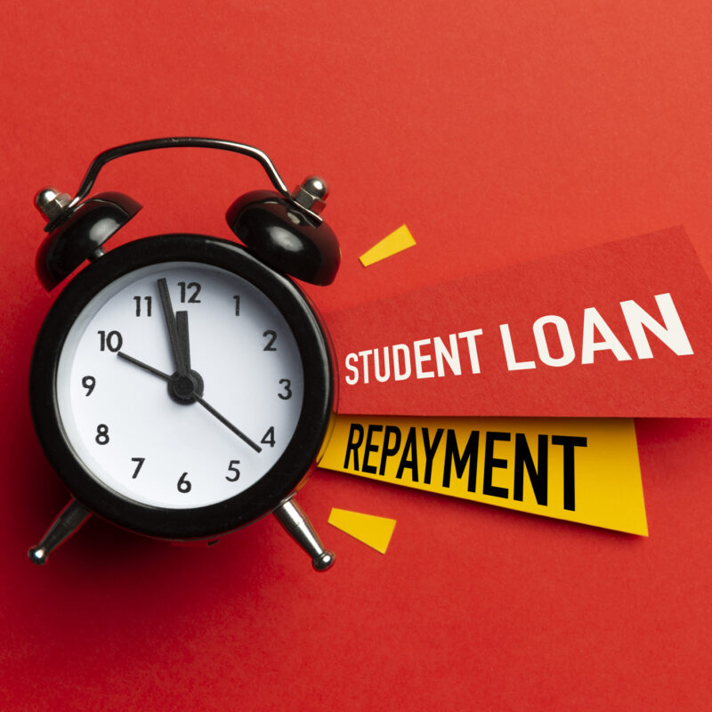 Red background, Alarm clock and the words "student loan repayment"