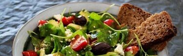 Mediterranean Salad with tomatoes, olives, and avocado.