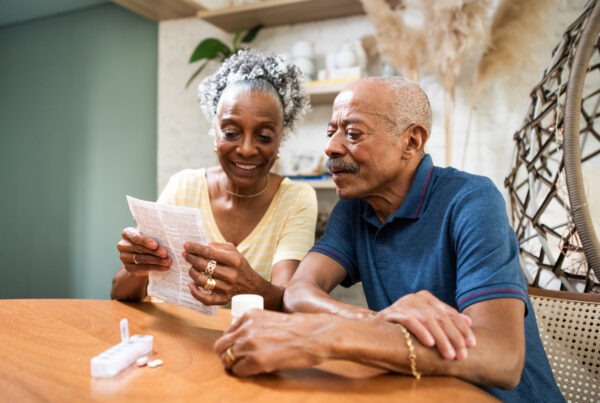 Senior adult taking medication at home