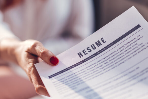 The concept of employment and job interviews. Young woman during job interview, main focus on CV.