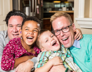 Parents and their children pose for a photo at home