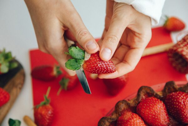 person cutting strawberry