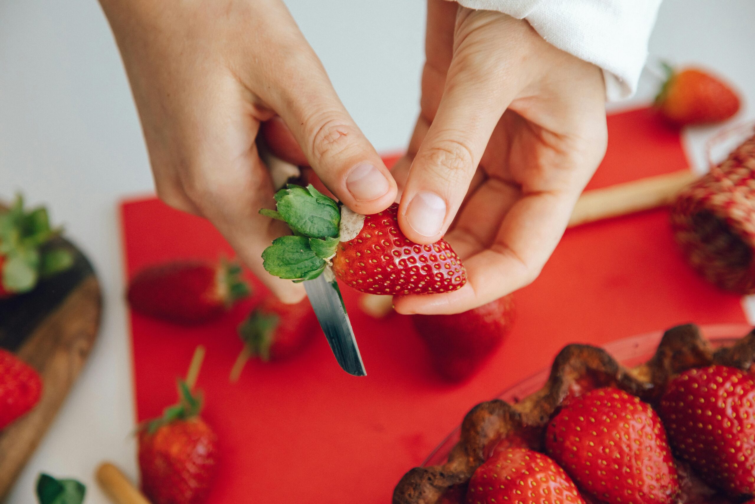 person cutting strawberry