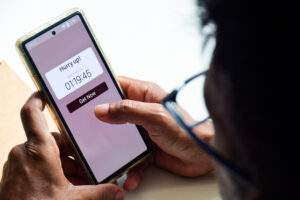 using phone displaying real-time notification about sales ending in a short time frame. FOMO Marketing strategy, online shopping concept.