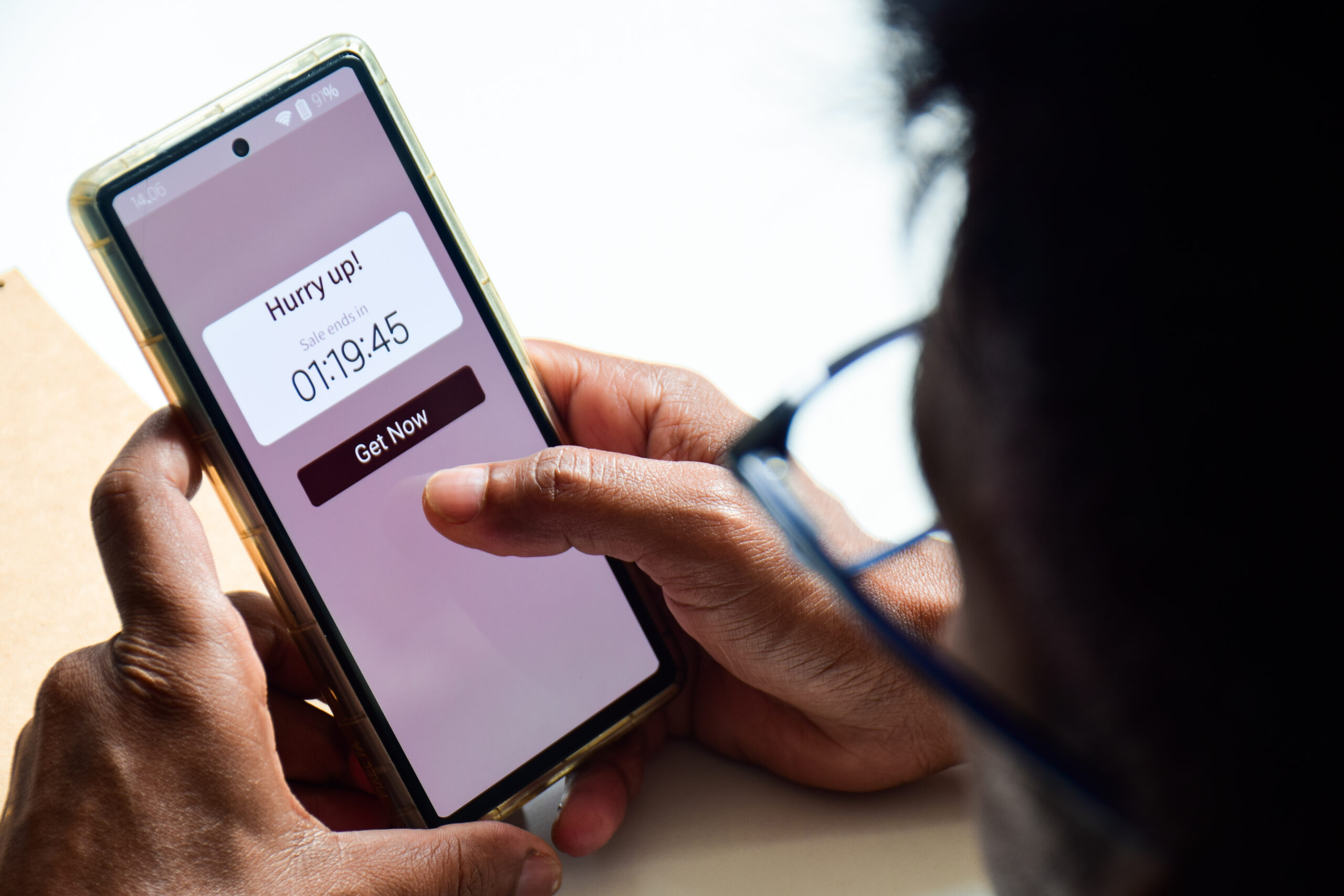 using phone displaying real-time notification about sales ending in a short time frame. FOMO Marketing strategy, online shopping concept.